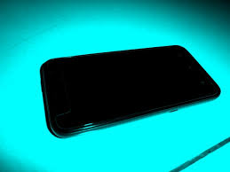 black cell phone, blue-green background