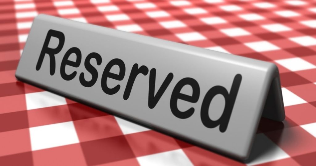 reserved sign on red and white checkered tablecloth